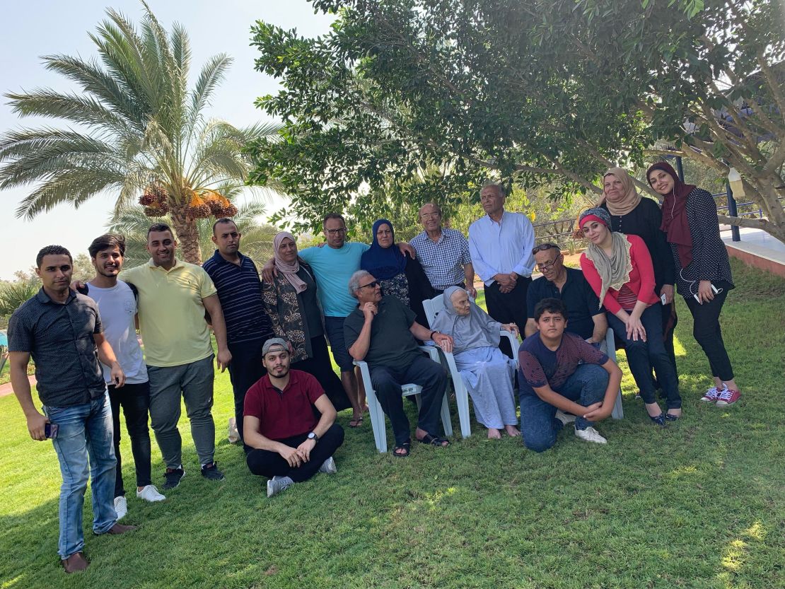 Aref Abou-Amro, in the center back with his arms over sisters, and the rest of the family, including many nephews and nieces, who are trapped in Gaza.