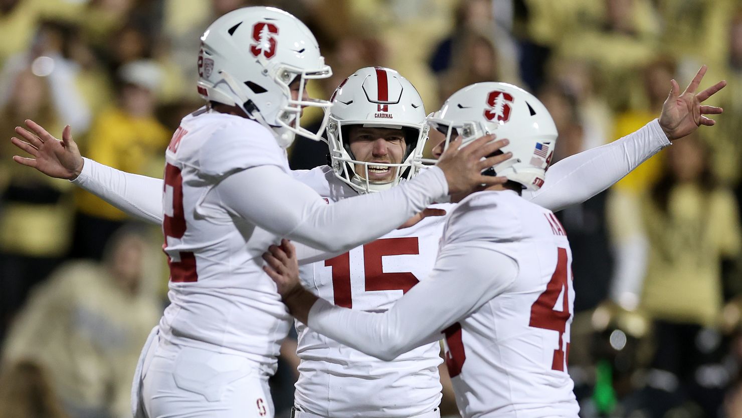 Joshua Karty #43 of the Stanford Cardinal celebrates with Bailey Parsons #42 and Connor Weselman #15 after kicking a field goal to tie the Colorado Buffaloes at the end of the fourth quarter at Folsom Field on October 13, 2023 in Boulder, Colorado.