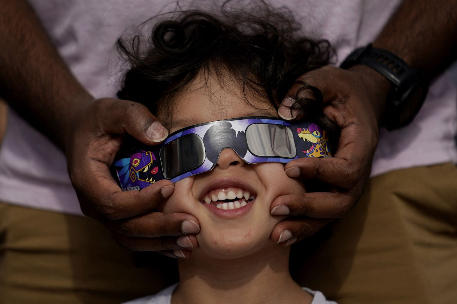 Viewers use special eclipse glasses to watch from San Antonio, Texas.