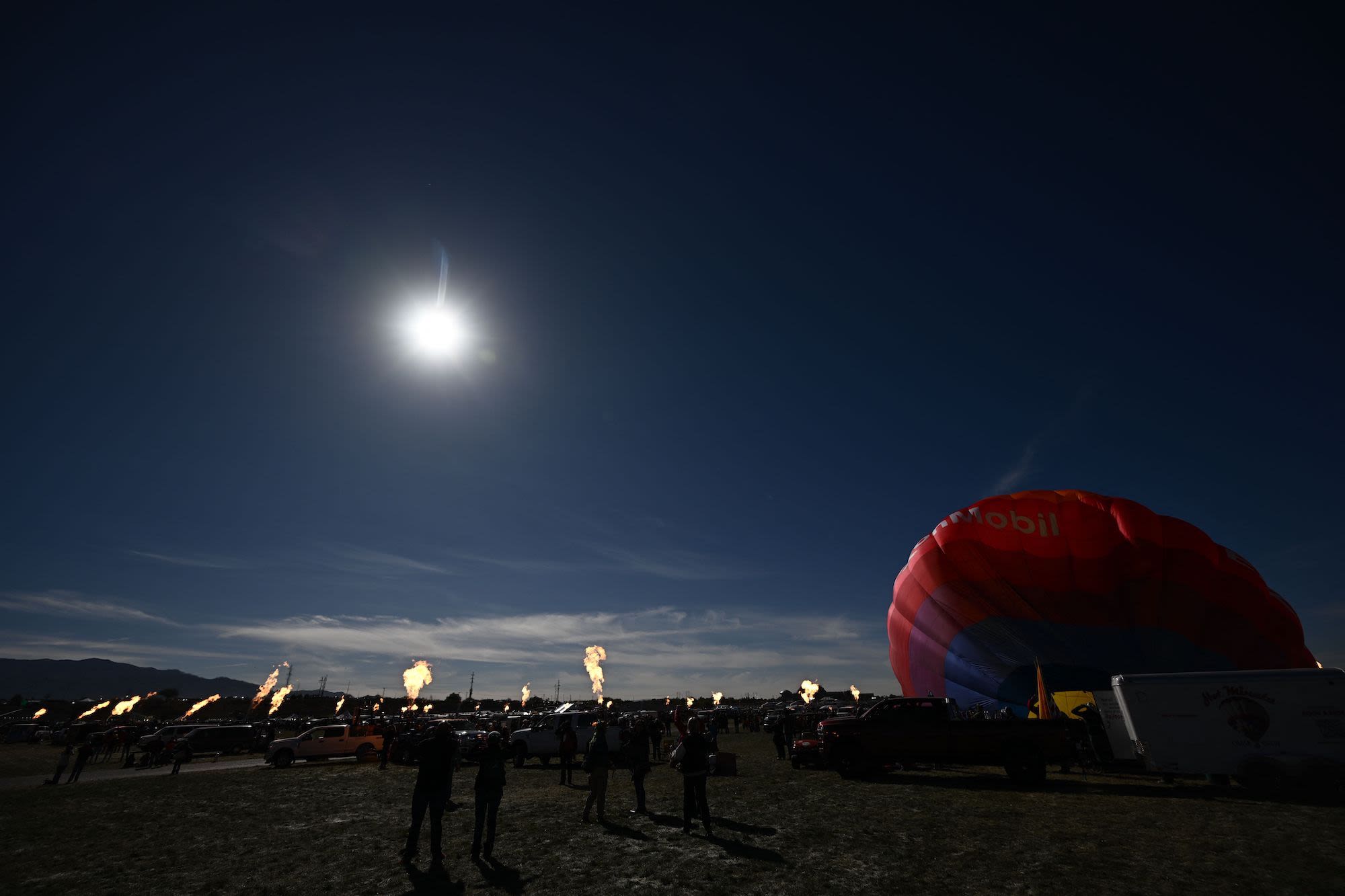 Hot air balloon operators create a 'ring of fire' with their gondola burners at the Albuquerque International Balloon Fiesta in Albuquerque, New Mexico.