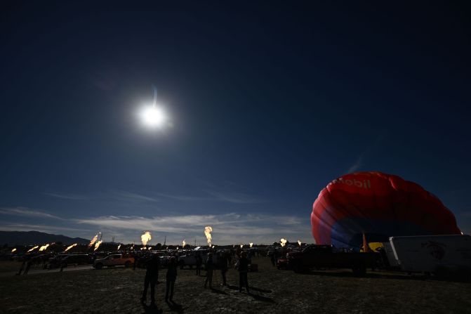 Hot air balloon operators create a "ring of fire" with their gondola burners at the Albuquerque International Balloon Fiesta in Albuquerque, New Mexico.