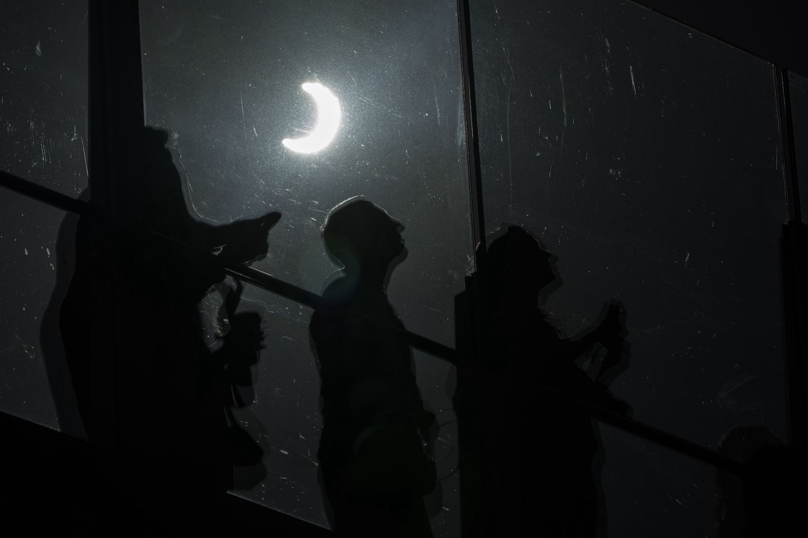 People watch the solar eclipse along the Las Vegas Strip.
