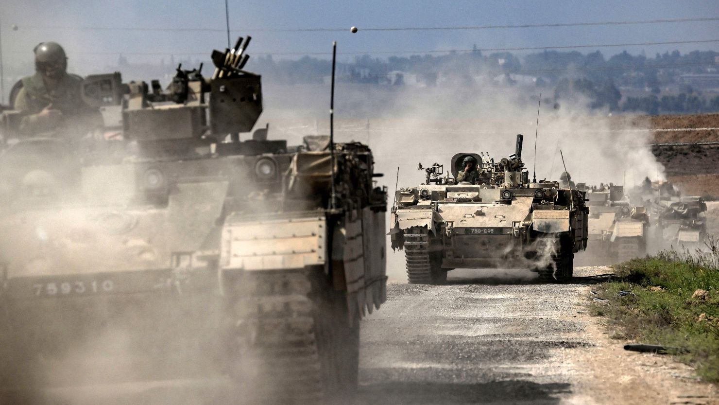 Israeli army Puma armored personnel carriers move in a column near the Gaza border in southern Israel on October 14, 2023. 