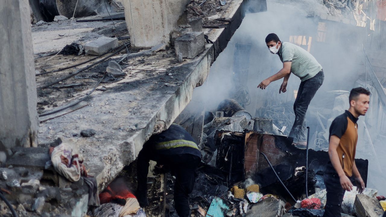 Palestinians search for casualties under the rubble in the aftermath of Israeli strikes, amid the ongoing conflict between Israel and the Palestinian Islamist group Hamas, in Khan Younis in the southern Gaza Strip, October 14.