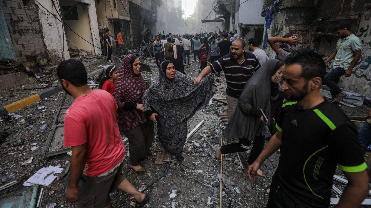 People at the site of an Israeli rocket attack in Al- Shati refugee camp in the west of Gaza City on October 14. 