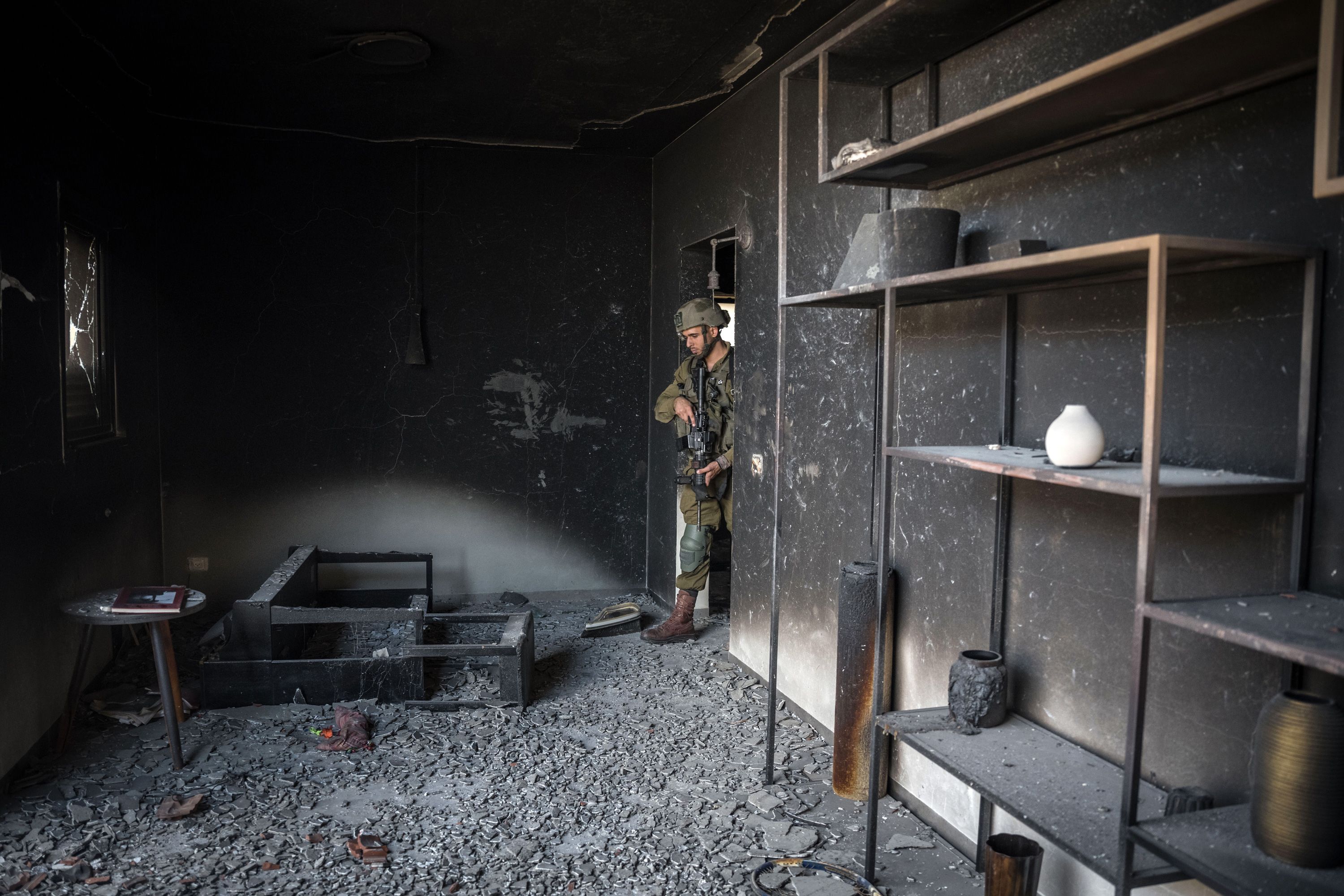 An Israeli soldier looks inside a house that was overrun by Hamas militants in Be'eri, Israel, on October 13.