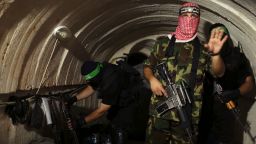 A Palestinian fighter from the Izz el-Deen al-Qassam Brigades, the armed wing of the Hamas movement, gestures inside an underground tunnel in Gaza August 18, 2014. A rare tour that Hamas granted to a Reuters reporter, photographer and cameraman appeared to be an attempt to dispute Israel's claim that it had demolished all of the Islamist group's border infiltration tunnels in the Gaza war. Picture taken August 18, 2014. REUTERS/Mohammed Salem (GAZA - Tags: POLITICS CONFLICT TPX IMAGES OF THE DAY)