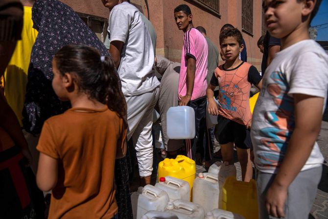 Palestinians collect water from a tap on October 15 after <a href="https://www.cnn.com/2023/10/10/middleeast/gaza-complete-siege-israel-intl/index.html" target="_blank">Israel blocked supplies</a> of electricity, food, water and fuel to Gaza.