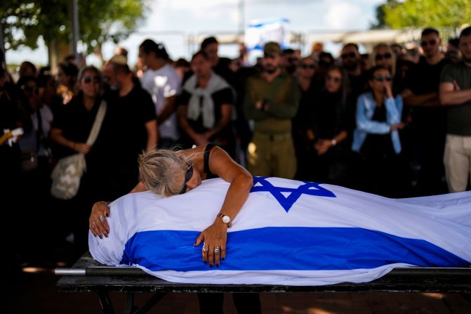 Antonio Macías' mother cries over her son's body at Pardes Haim cemetery in Kfar Saba, Israel, on October 15. Macías was killed by Hamas at an <a href="index.php?page=&url=https%3A%2F%2Fwww.cnn.com%2F2023%2F10%2F07%2Fmiddleeast%2Fisrael-gaza-fighting-hamas-attack-music-festival-intl-hnk%2Findex.html" target="_blank">Israeli music festival</a> earlier this month.