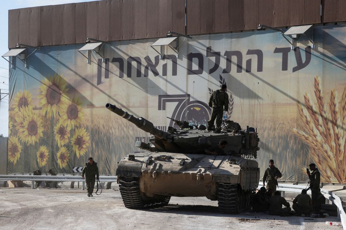 Israeli soldiers gather on and around a tank near Israel's border with the Gaza Strip, in southern Israel on October 15.