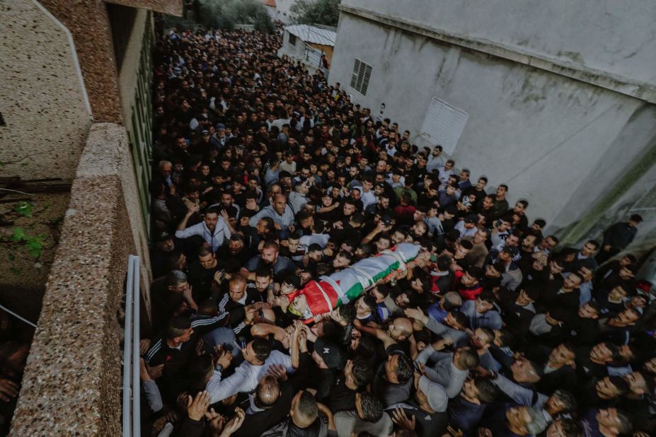 Mourners carry the body of a Palestinian youth during his funeral in Nablus, West Bank, on October 15.