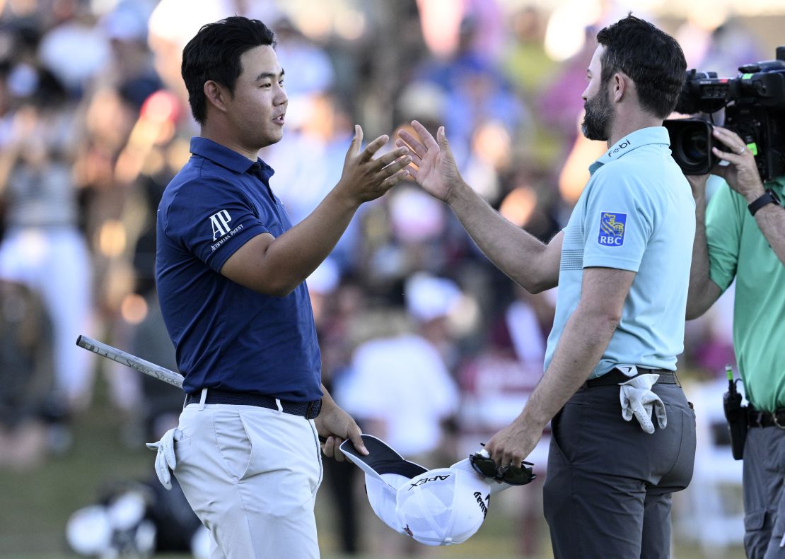 LAS VEGAS, NEVADA - OCTOBER 15: Tom Kim of South Korea shakes hands with Adam Hadwin of Canada after their round on the 18th green during the final round of the Shriners Children's Open at TPC Summerlin on October 15, 2023 in Las Vegas, Nevada. (Photo by Orlando Ramirez/Getty Images)
