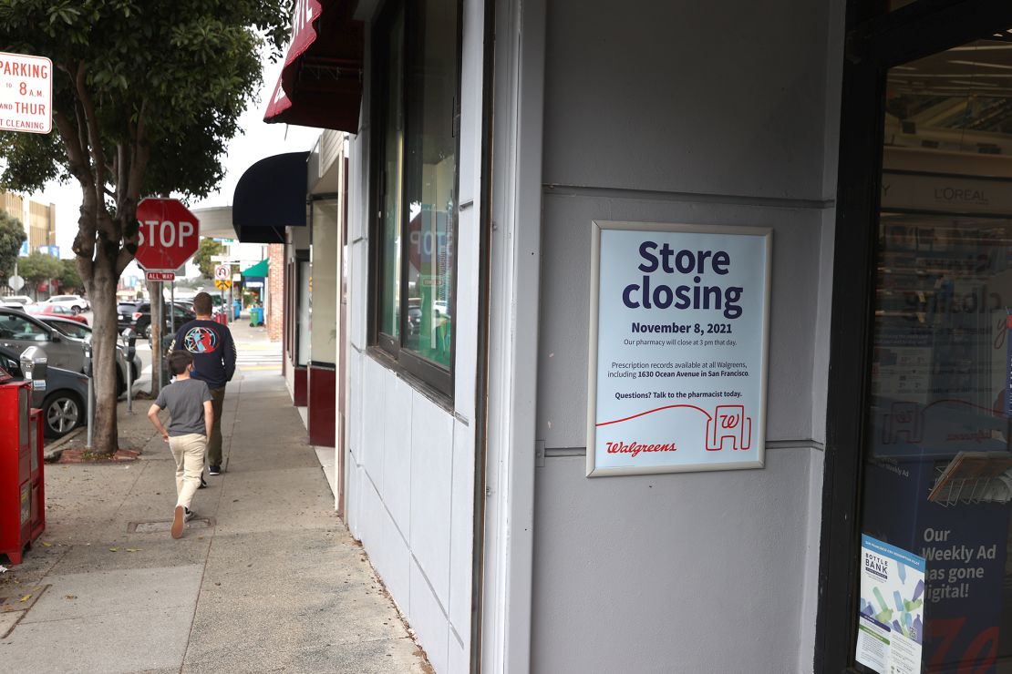 Pedestrians walk by a Walgreens store that is set to be closed in the coming weeks on October 13, 2021 in San Francisco, California. Walgreens announced plans to close five of its San Francisco stores due to organized retail shoplifting that has plagued its stores in the city. The retail pharmacy chain has already shuttered 10 stores in the city since 2019.