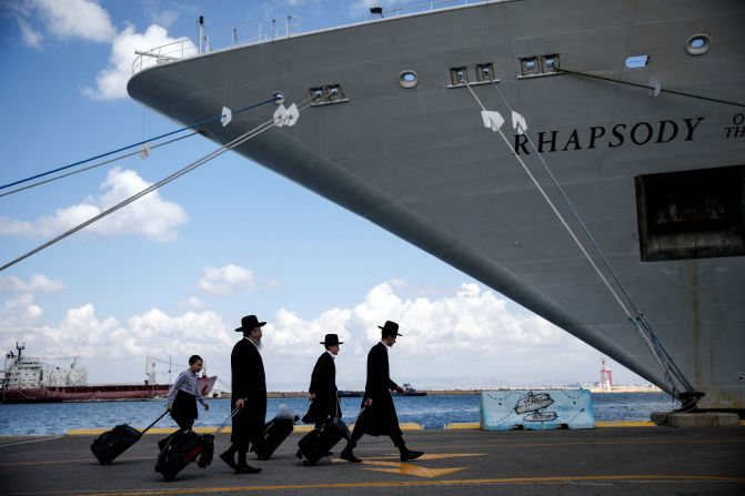 People prepare to board a ship that will transport US nationals and their immediate family members from Haifa, Israel, to Cyprus on October 16.