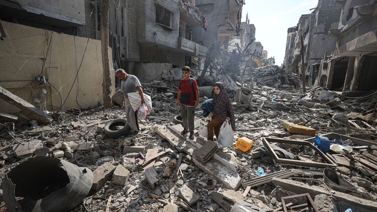 Palestinians look for their belongings in the rubble in Gaza City, on Monday. Attacks by the Israeli military have destroyed entire neighborhoods inside the strip.