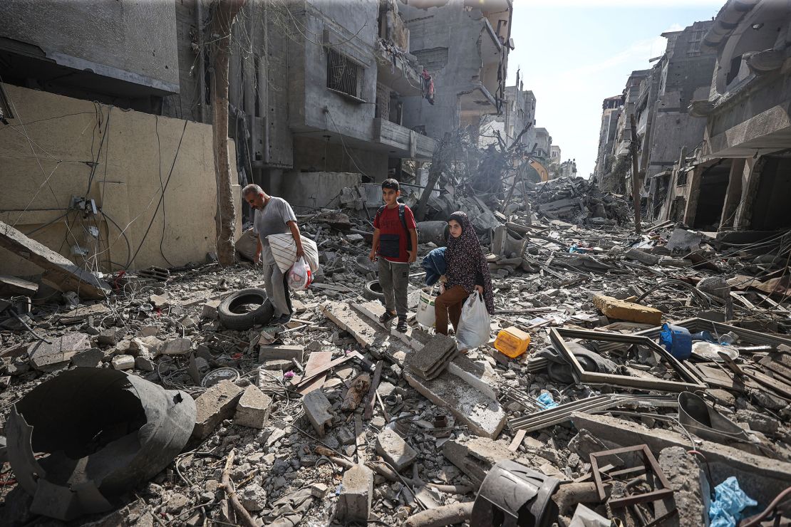 Palestinians look for their belongings in the rubble in Gaza City, on Monday. Attacks by the Israeli military have destroyed entire neighborhoods inside the strip.