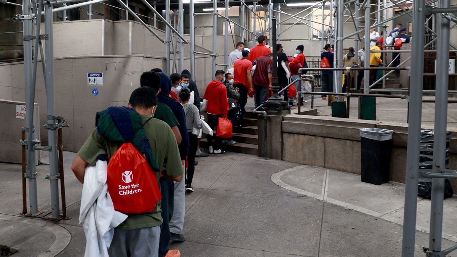 Migrants are pictured entering a shelter in Manhattan, New York, in 2022. 
