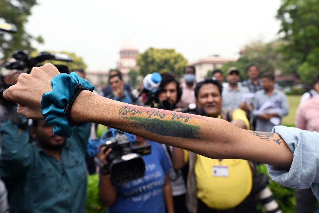An activist displays a tattoo reading "Born this way" in the courtyard of India's Supreme Court in New Delhi on October 17, 2023.