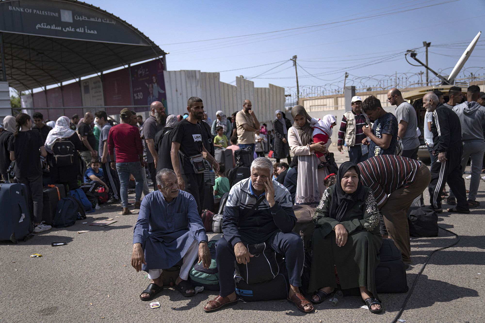 Palestinians wait to cross into Egypt at the Rafah border crossing in Gaza on October 16.
