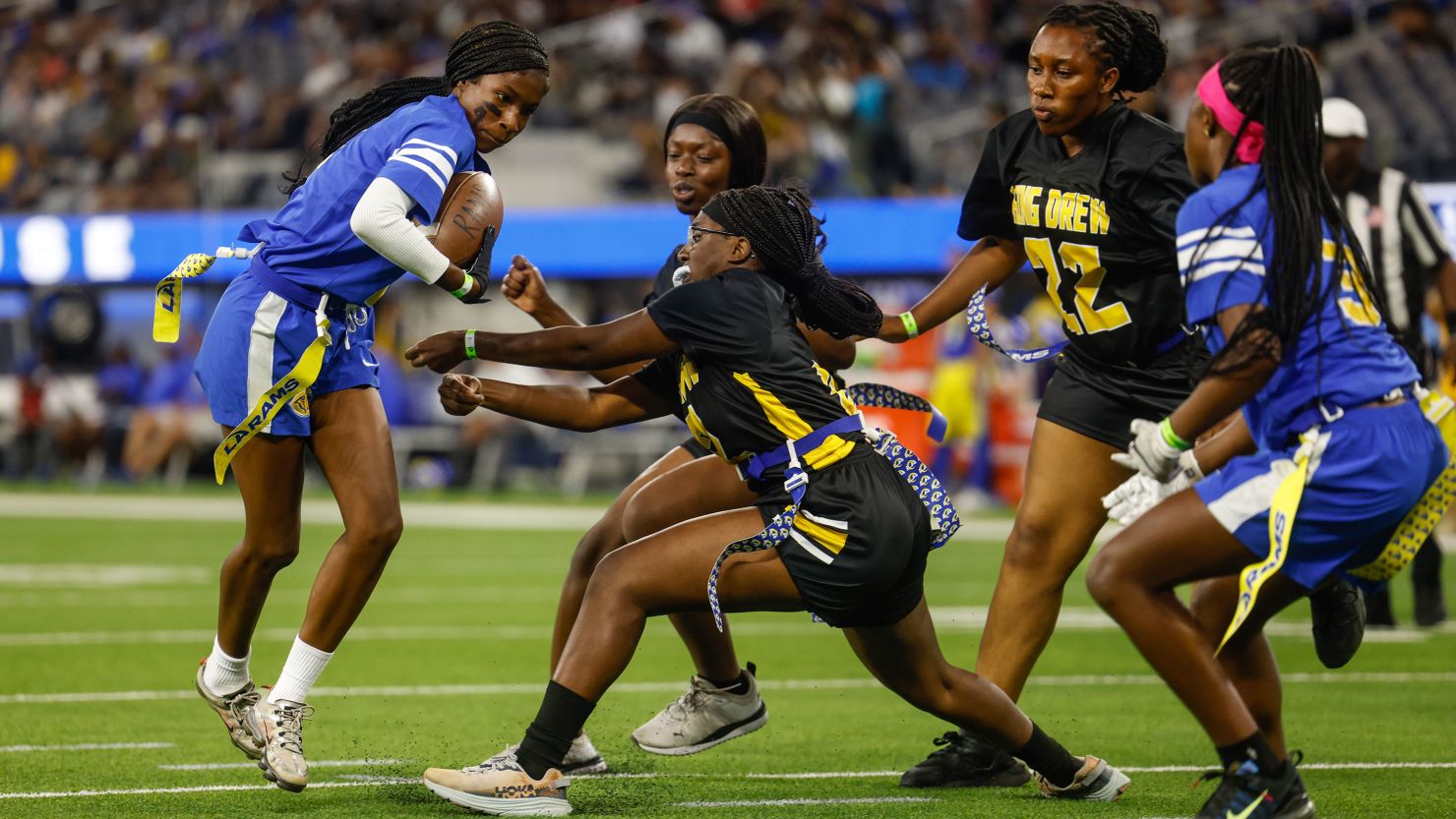 Inglewood, CA - August 19: A player for for Crenshaw girls flag football runs the ball as they play King/Drew at halftime of the Rams and Raiders preseason game at SoFi Stadium on Saturday, Aug. 19, 2023 in Inglewood, CA. (Jason Armond/Los Angeles Times via Getty Images)