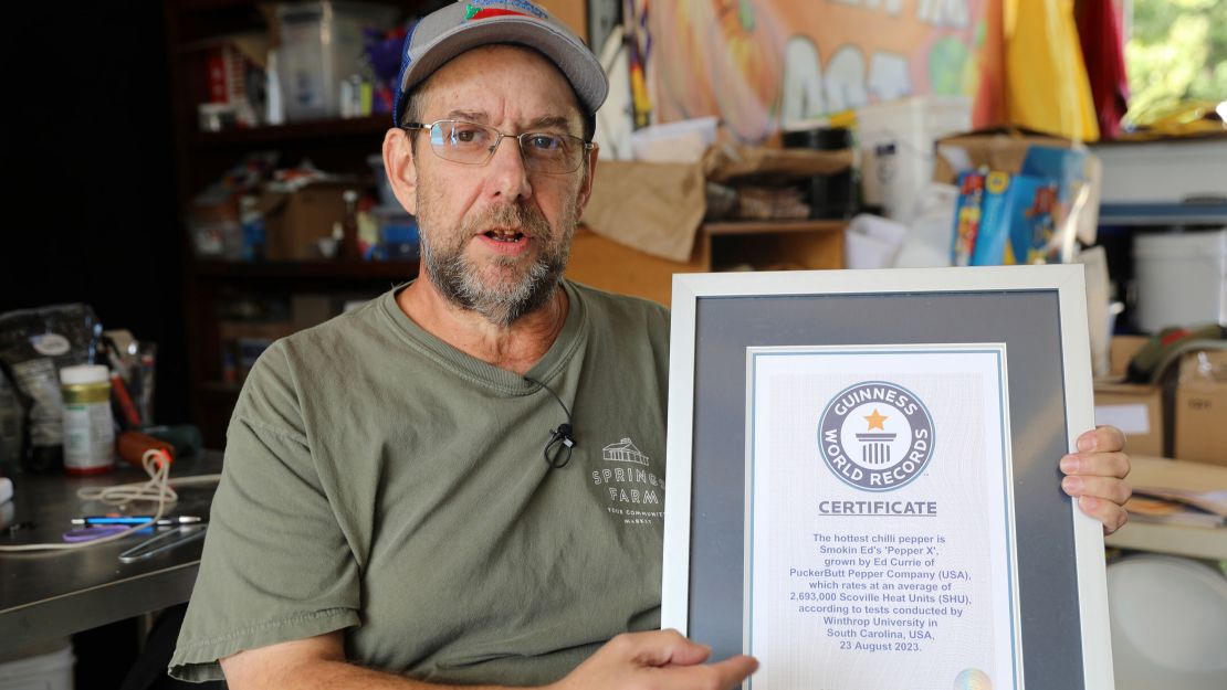 Ed Currie holds up certification that his new Pepper X variety of peppers is the hottest in the world, according to the Guinness Book of World Records