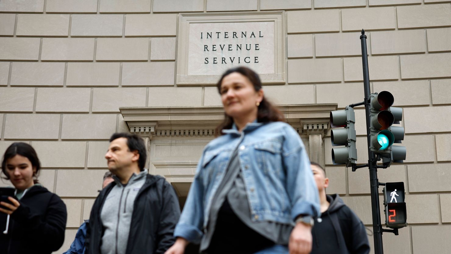 Tourists walk past the headquarters of the Internal Revenue Service near the National Mall on April 7 in Washington, DC. 