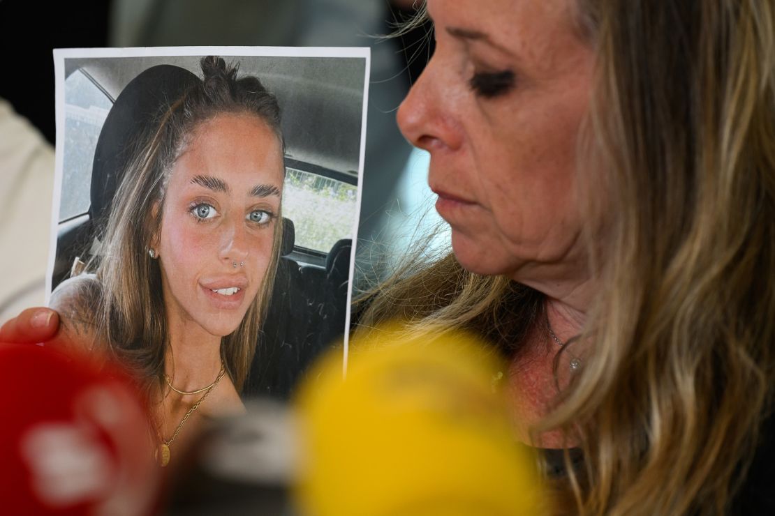 Keren Scharf Schem holds a photo of her daughter, Mia, at a press conference in Tel Aviv, Israel, October 17, 2023.