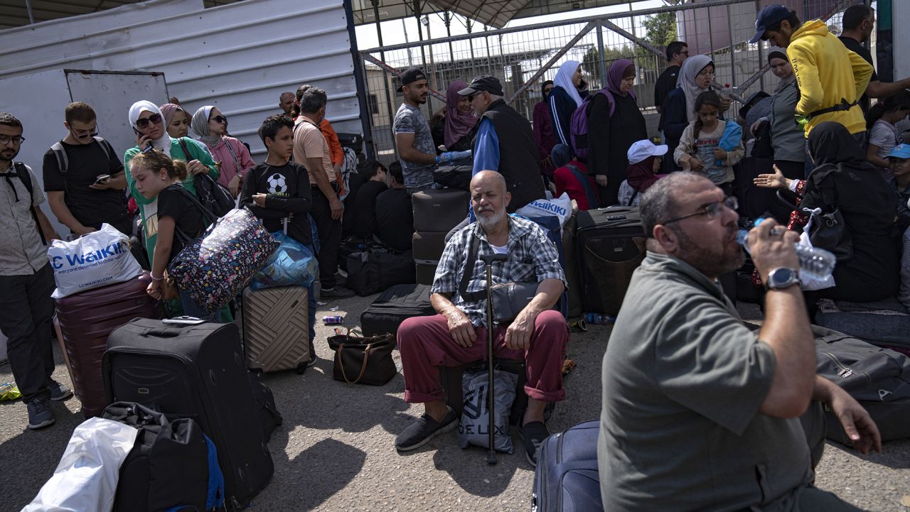 Palestinians wait to cross into Egypt at the Rafah border crossing on Monday, Oct.16, 2023. (AP Photo/Fatima Shbair)