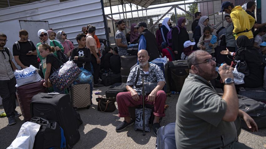 Palestinians wait to cross into Egypt at the Rafah border crossing on Monday, Oct.16, 2023. (AP Photo/Fatima Shbair)