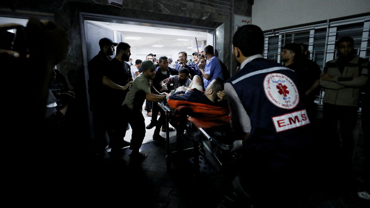 An injured person is being helped after the Al-Ahli Baptist Hospital was bombed on Tuesday. 