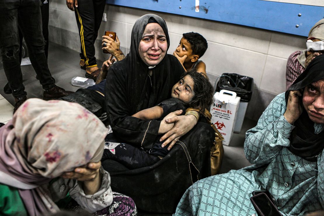 Women and children wait for treatment at Al-Shifa Hospital on Tuesday night.