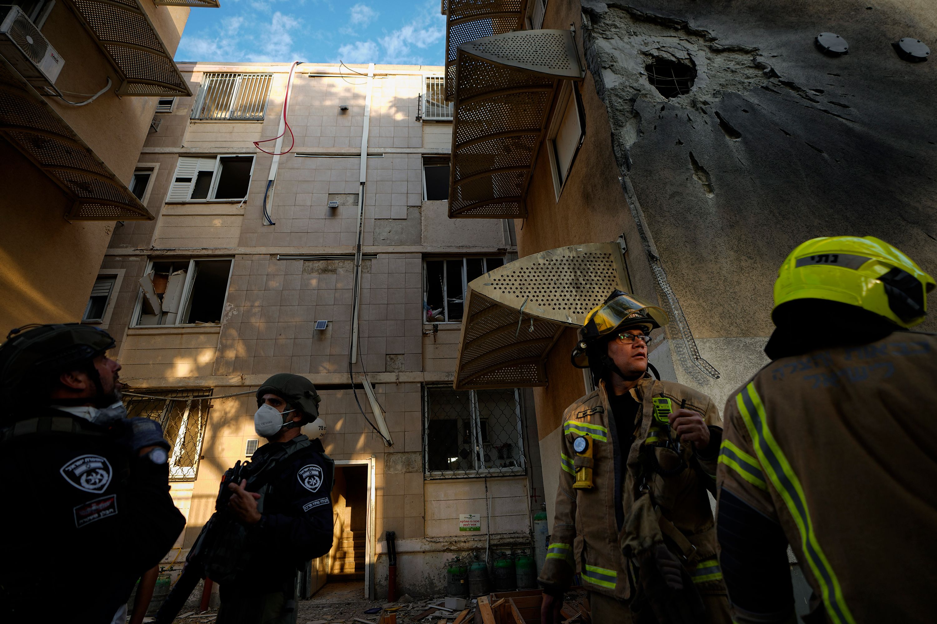 Israeli security forces inspect a damaged residential building after it was hit by a rocket fired from Gaza in Sderot, Israel on October 17.