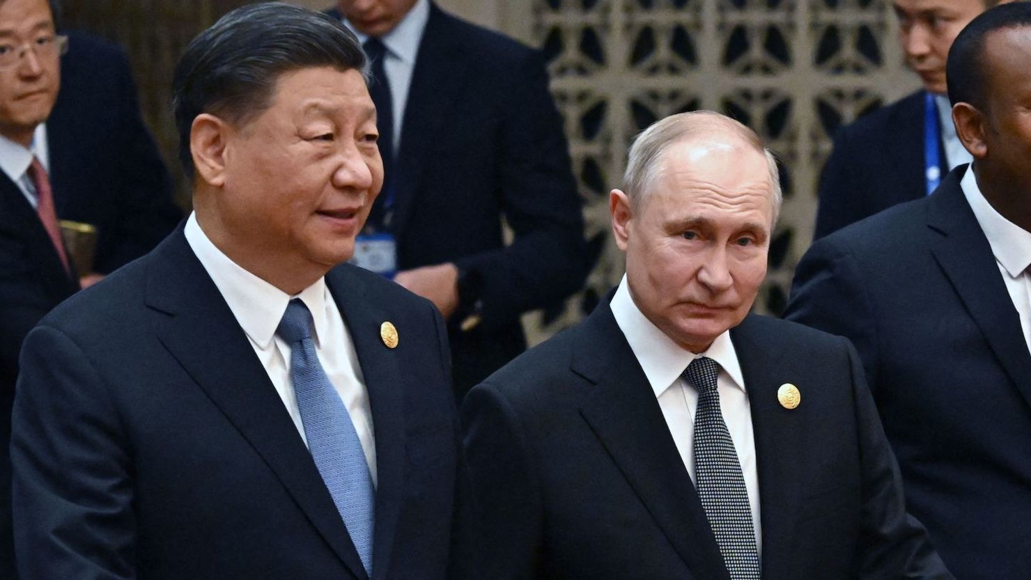 Chinese leader Xi Jinping and Russia's President Vladimir Putin head to a group photo session during the third Belt and Road Forum at the Great Hall of the People in Beijing on October 18.