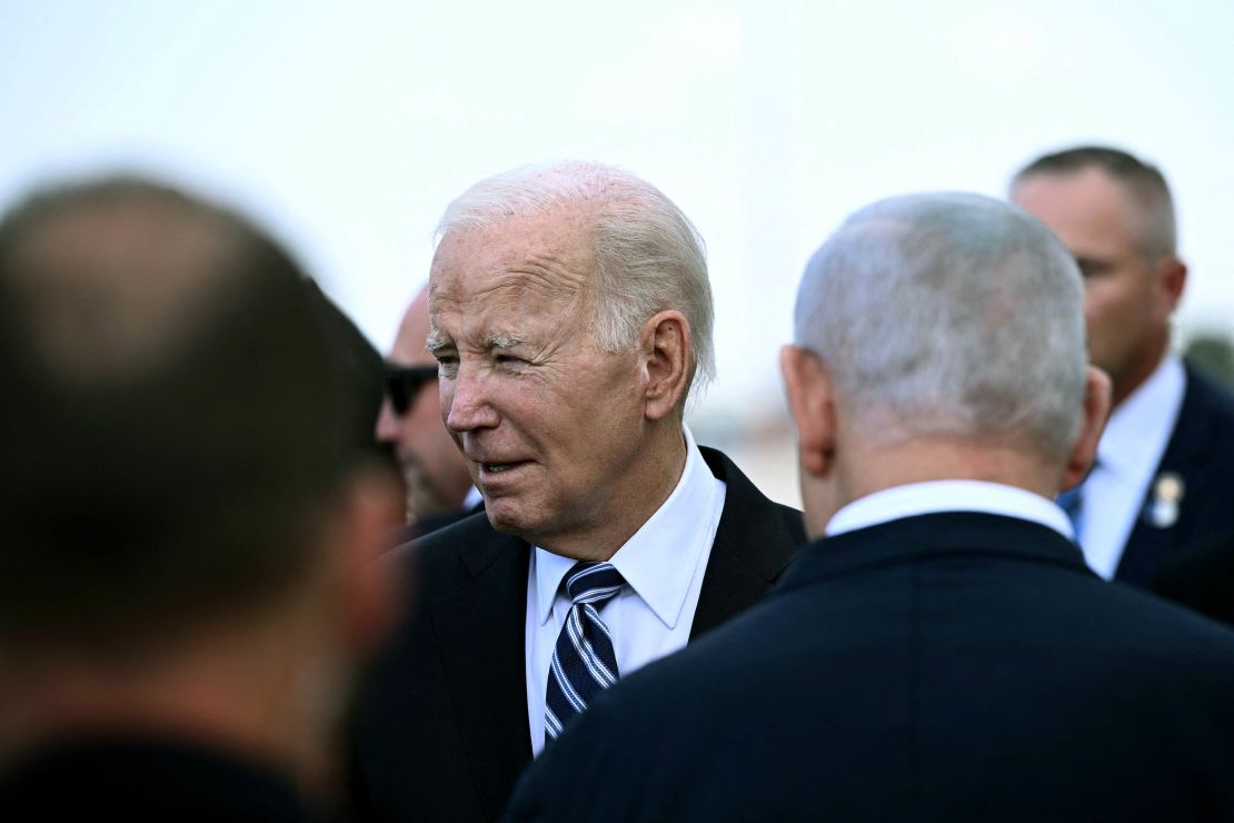 Israel Prime Minister Benjamin Netanyahu (back L) greets US President Joe Biden upon his arrival at Tel Aviv's Ben Gurion airport on October 18, 2023, amid the ongoing battles between Israel and the Palestinian group Hamas. Biden landed in Israel on October 18, on a solidarity visit following Hamas attacks that have led to major Israeli reprisals. (Photo by Brendan Smialowski / AFP) (Photo by BRENDAN SMIALOWSKI/AFP via Getty Images)