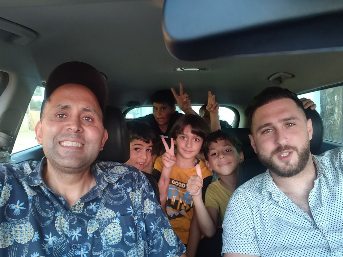 Writer Hani Almadhoun (left) on a road to trip to Beit Lahia beach, with his nieces and nephews in the back of the car, during a visit to Gaza over summer this year.