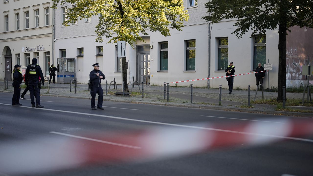 German police officers stand guard in front of a building that houses the targeted synagogue in Berlin's Mitte neighborhood.