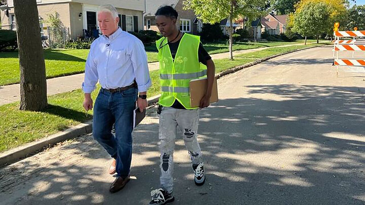 John King accompanies Devonta Johnson, a canvasser with the group Black Leaders Organizing for Communities, on a door-knocking shift  in Milwaukee in October.