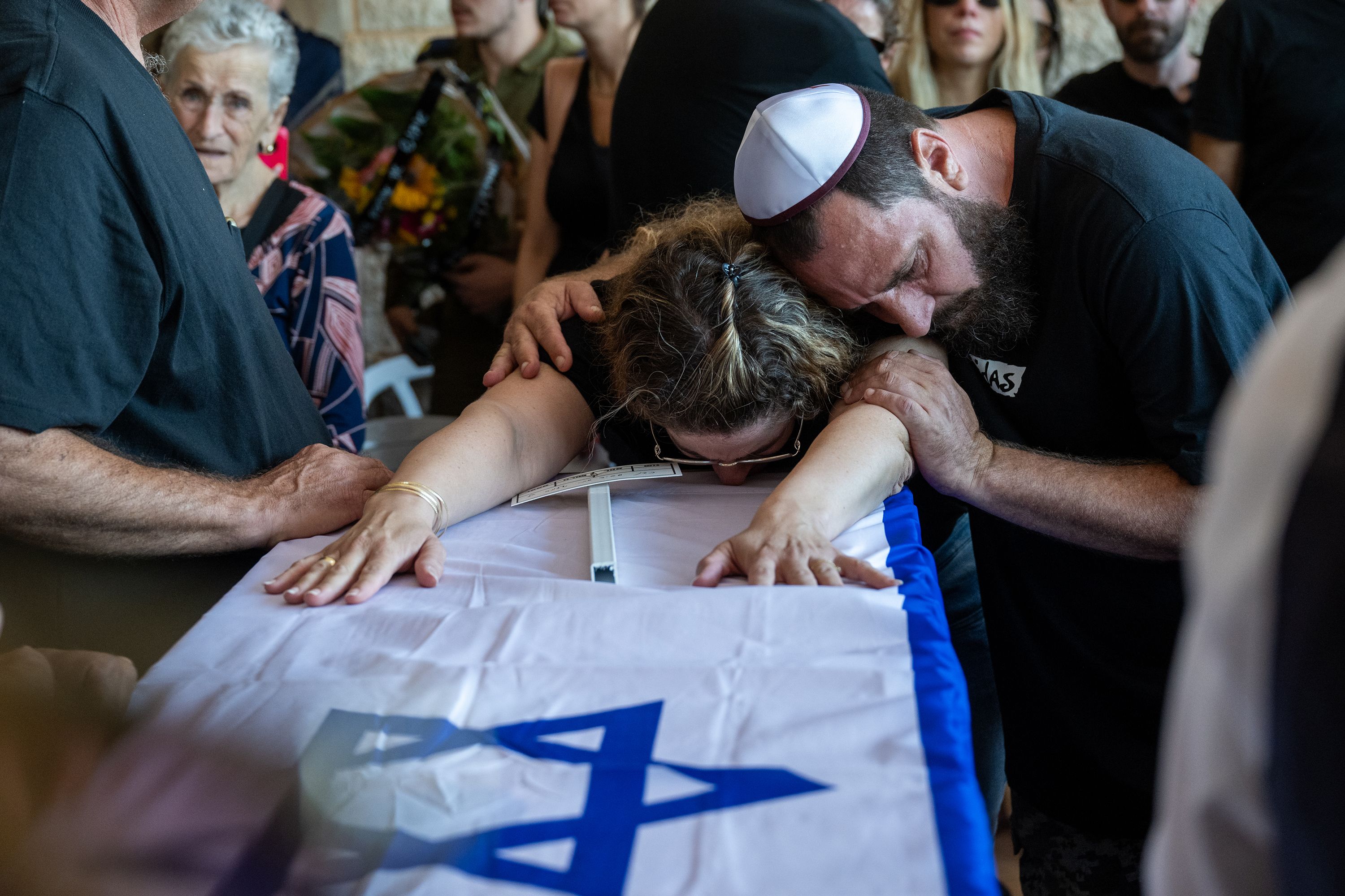 People mourn a family during a funeral in Hod HaSharon, Israel, on October 18.