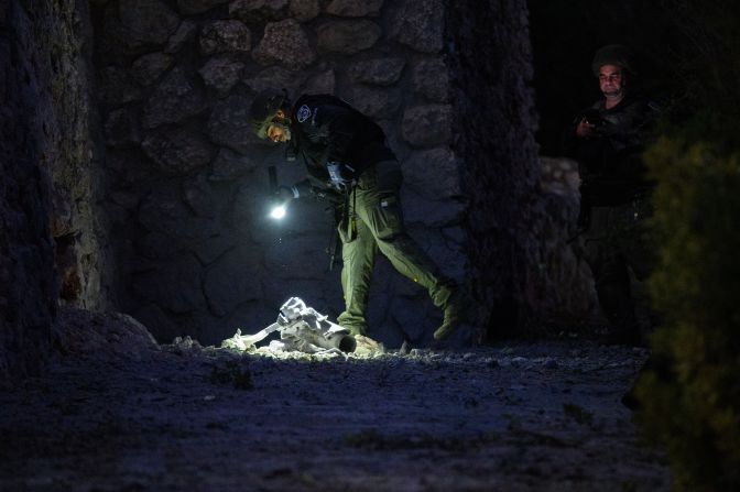 Israeli security inspects debris from a rocket in Kiryat Shmona, Israel, on October 18.