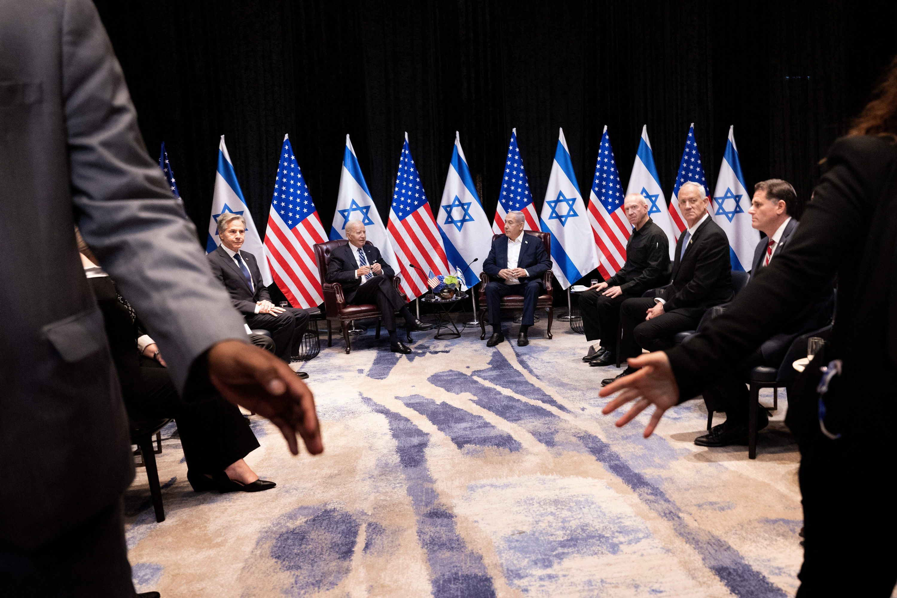 From left, US Secretary of State Antony Blinken and US President Joe Biden join Israel's Prime Minister Benjamin Netanyahu and other Israeli officials as they wait for the start of the Israeli war cabinet meeting in Tel Aviv on October 18.