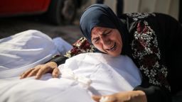 GAZA CITY, GAZA - OCTOBER 18: Relative mourns over a dead body of a man at the Suheda al-Aqsa Hospital (Al-Aqsa Martyrs Hospital) as Israel's attacks on the Gaza Strip continue on its 12th day in Gaza City, Gaza on October 18, 2023. (Photo by Belal Khaled/Anadolu via Getty Images)