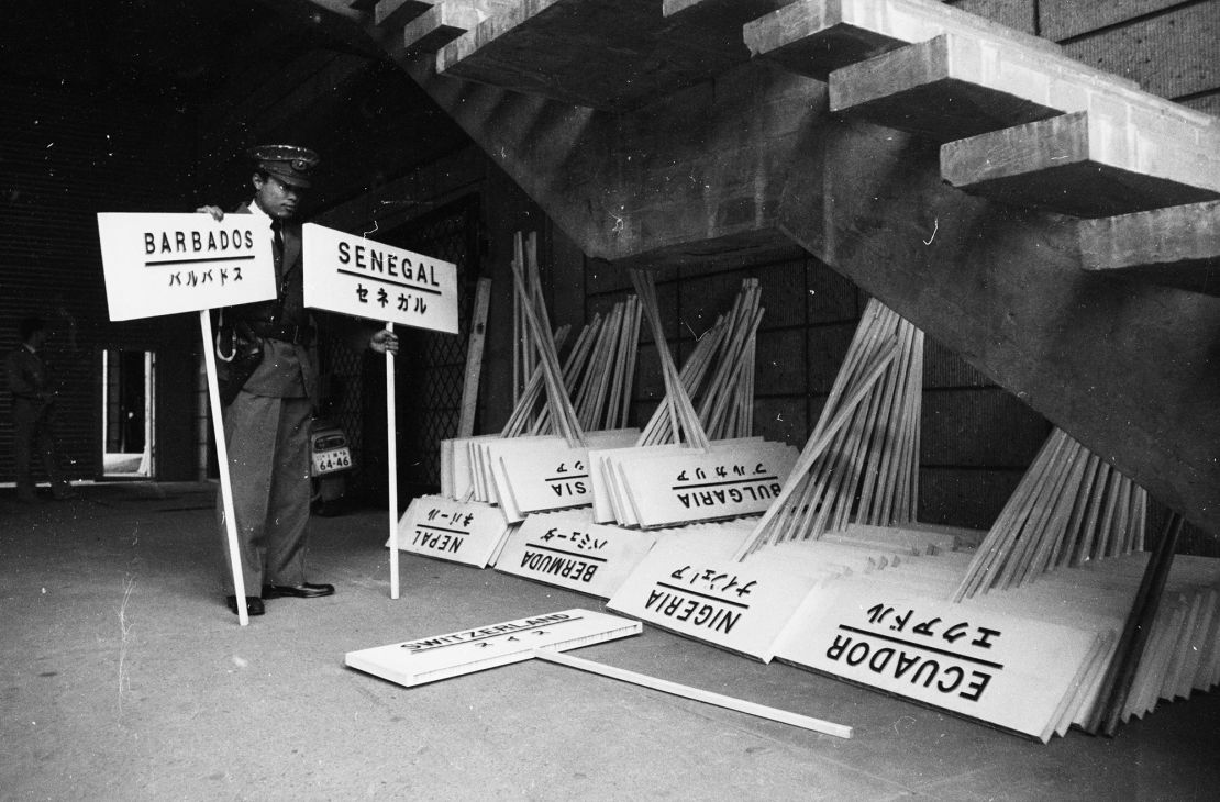 September 1964: A Japanese policeman checking the signs to be used during the opening parade at the Olympic Games in Tokyo. (Photo by Douglas Miller/Keystone Features/Hulton Archive/Getty Images)