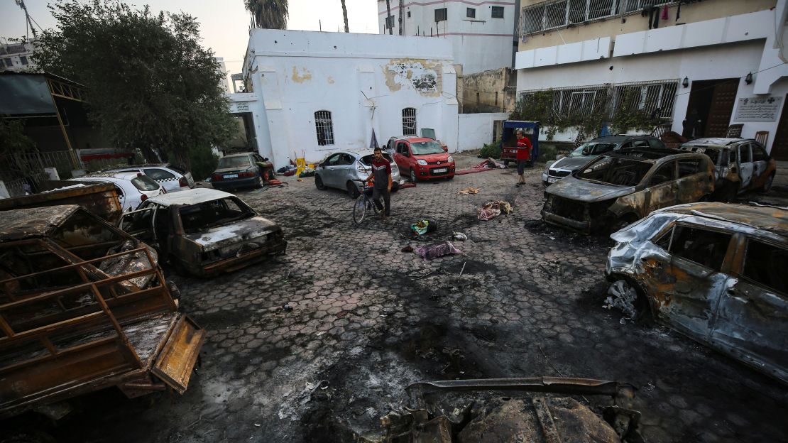 Palestinians assess the aftermath of the explosion at Al-Ahli Hospital on Wednesday, October 18.