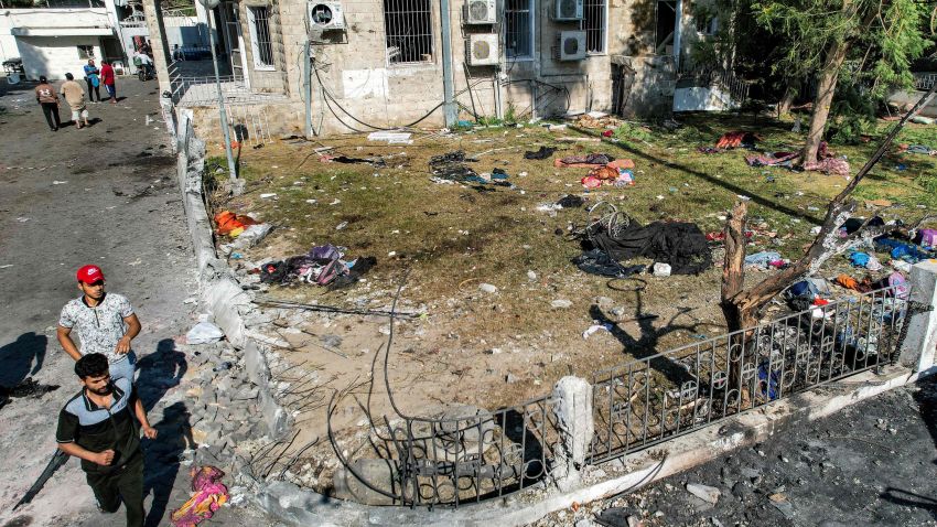 This aerial view shows people walking at the site of the Ahli Arab hospital in central Gaza on October 18, 2023 in the aftermath of an overnight strike there. A blast ripped through a hospital in war-torn Gaza killing hundreds of people late on October 17, sparking global condemnation and angry protests around the Muslim world. Israel and Palestinians traded blame for the incident, which an "outraged and deeply saddened" US President Joe Biden denounced while en route to the Middle East. (Photo by Shadi AL-TABATIBI / AFP) (Photo by SHADI AL-TABATIBI/AFP via Getty Images)