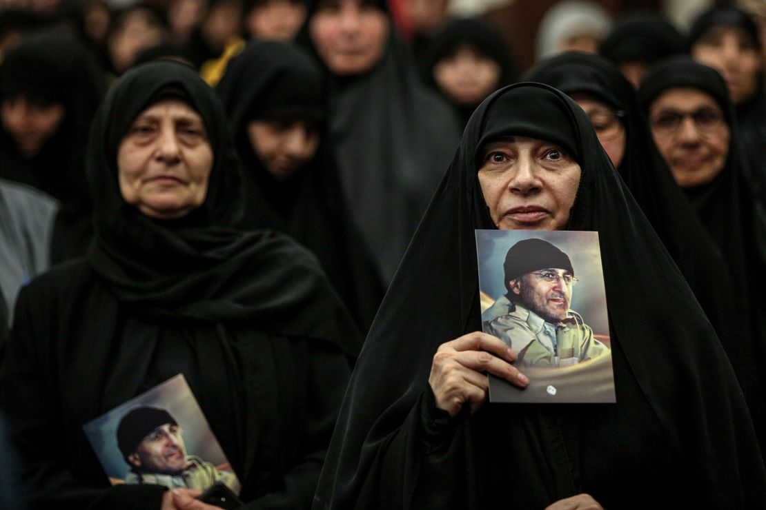 Women carry the images of late Hezbollah commander Mustafa Badreddine during a ceremony in Beirut on May 12.