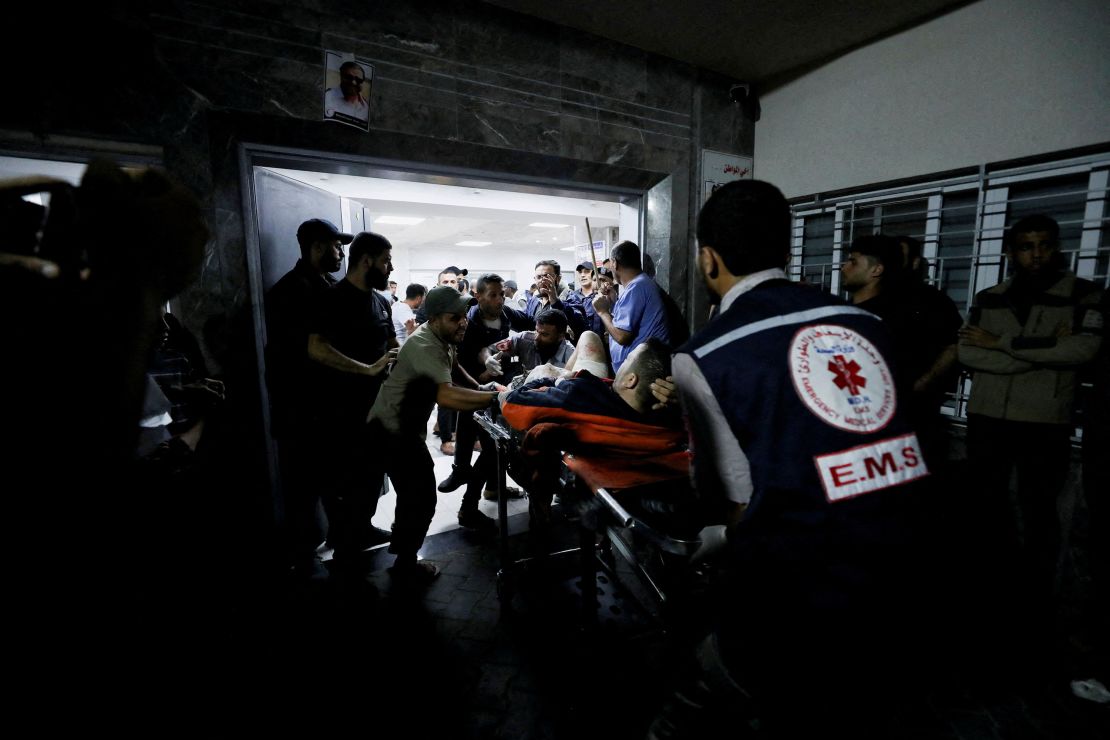 An injured person is assisted by medical personnel at the Al-Shifa Hospital after a blast at Al-Ahli Baptist Hospital in Gaza City on Tuesday, October 17.