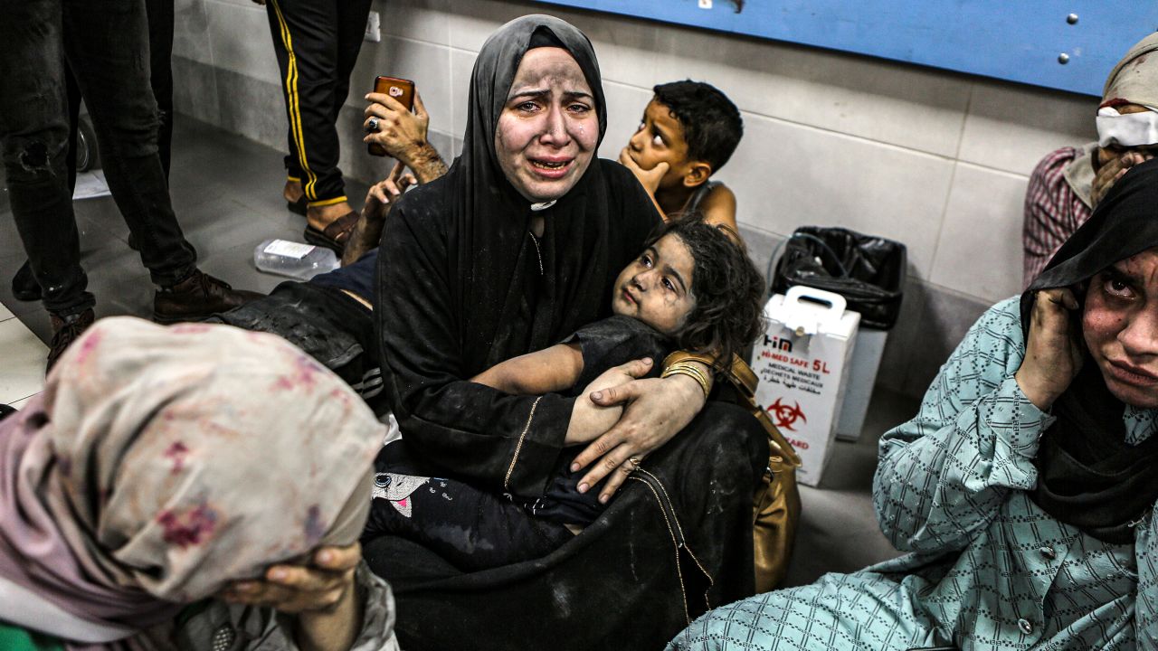Wounded Palestinians sit in al-Shifa hospital in Gaza City, central Gaza Strip, after arriving from al-Ahli hospital following an explosion there, Tuesday, Oct. 17, 2023. 