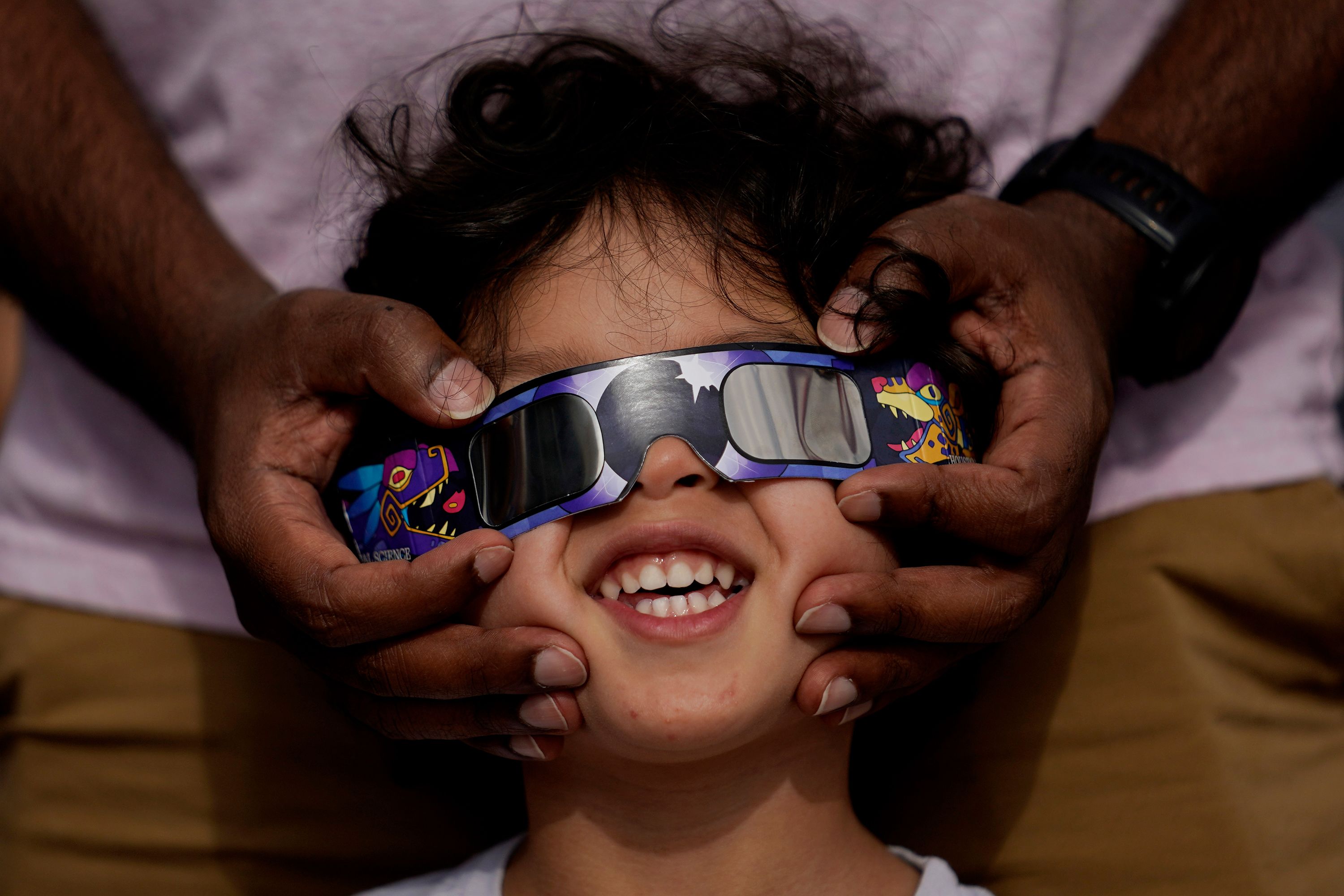 People use special glasses to view the annular solar eclipse from San Antonio.