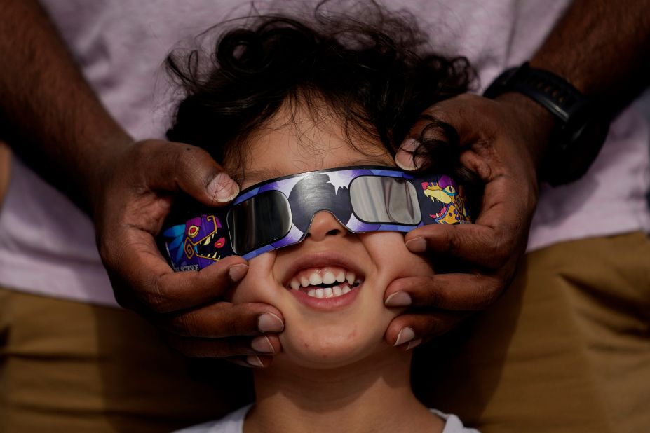 People use special glasses to view the annular solar eclipse from San Antonio on Saturday, October 14. <a href=