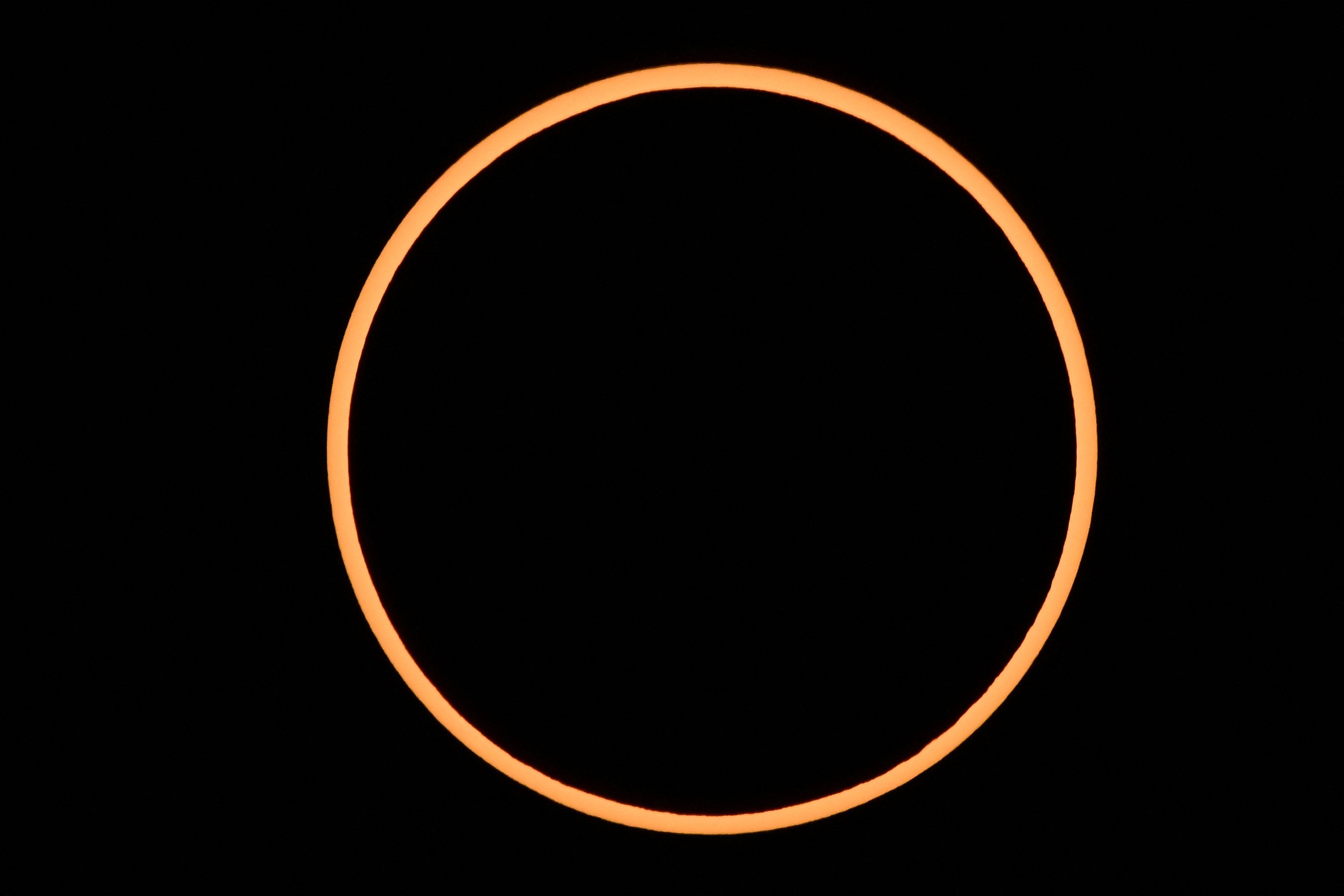 The moon passes between Earth and the sun during a rare 'ring of fire' solar eclipse.